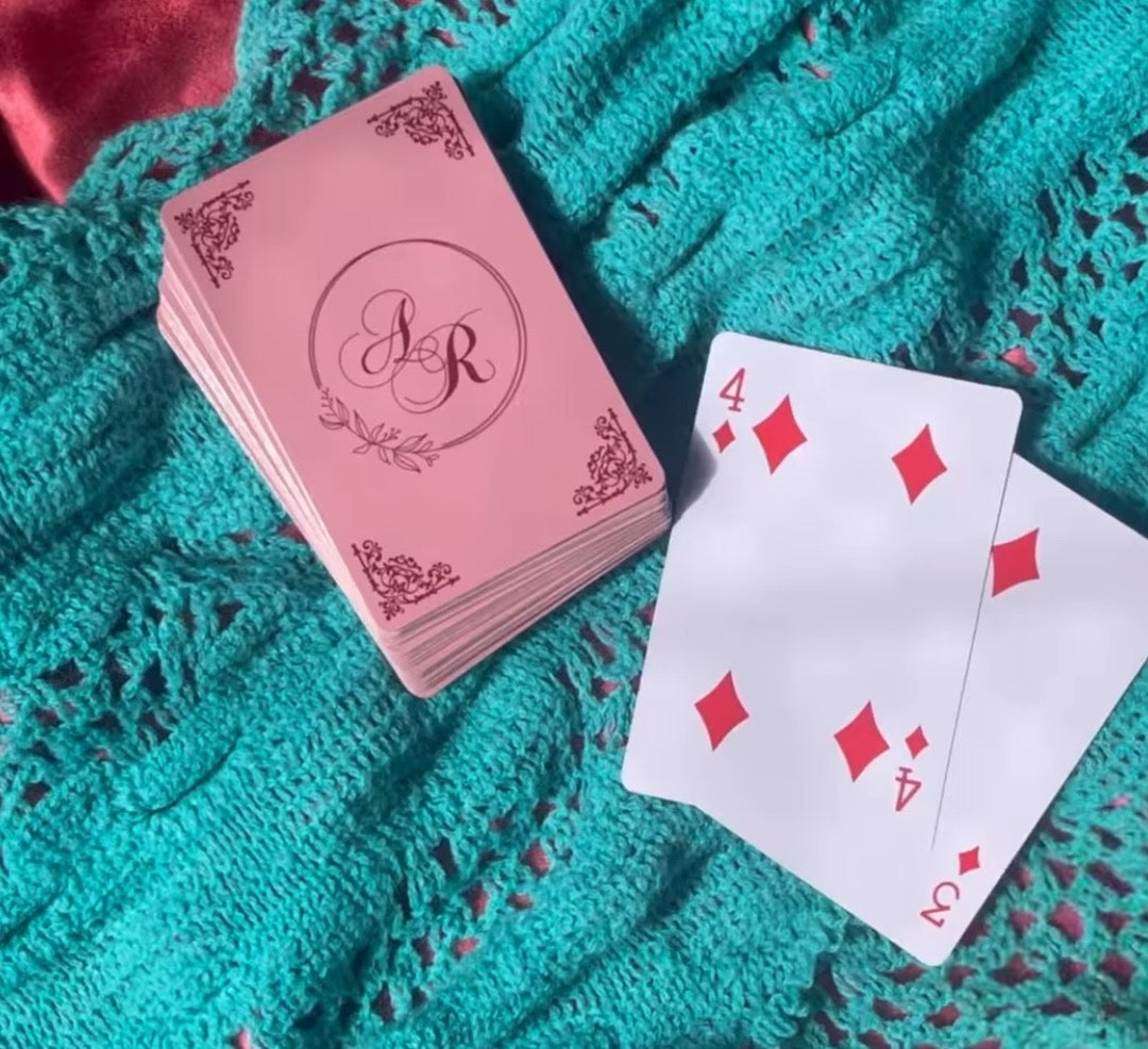A deck of playing cards with a personalized logo and the number cards