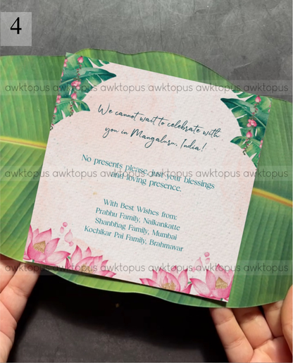 Invitation card with floral design held by hands on a leaf background